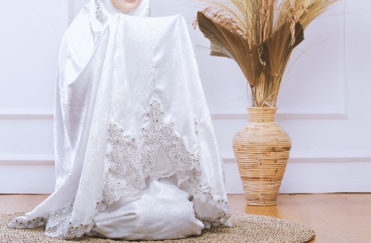 Ilustrasi perempuan mengenakan mukena saat beribadah. (Shutterstock)